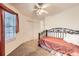 Cozy bedroom featuring a window, ceiling fan, and comfortable daybed at 7774 S Biloxi Way, Aurora, CO 80016