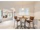 Cozy dining area featuring a table and chairs next to an opening to the living room at 7774 S Biloxi Way, Aurora, CO 80016