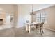 Bright dining room showcasing a chandelier, light walls, and lots of natural light at 7774 S Biloxi Way, Aurora, CO 80016