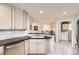 Modern kitchen featuring stainless steel appliances, light cabinets, and an open layout at 7774 S Biloxi Way, Aurora, CO 80016