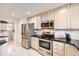 Updated kitchen with stainless steel appliances and light-colored cabinets at 7774 S Biloxi Way, Aurora, CO 80016