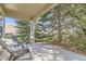 Covered porch featuring two chairs with a view of mature trees at 7774 S Biloxi Way, Aurora, CO 80016