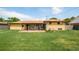 Expansive backyard with lush lawn, mature trees, and a sunroom, perfect for outdoor enjoyment at 85 S Flower St, Lakewood, CO 80226