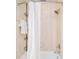 Bright bathroom features a shower/tub combo with shower curtain and chrome fixtures at 85 S Flower St, Lakewood, CO 80226