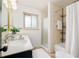 Bathroom featuring a shower and tub combination, neutral colors, and sink with vanity at 85 S Flower St, Lakewood, CO 80226