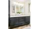 Bathroom vanity with dual sinks, classic tile flooring, and plenty of storage and counter space at 85 S Flower St, Lakewood, CO 80226