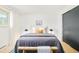 Comfortable bedroom featuring ample light, a large bed, stylish accents and hardwood floors at 85 S Flower St, Lakewood, CO 80226