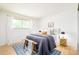 Comfortable bedroom featuring ample light, a large bed, stylish accents and hardwood floors at 85 S Flower St, Lakewood, CO 80226