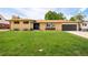 Charming, single-story brick home with a lush lawn and a covered front porch at 85 S Flower St, Lakewood, CO 80226