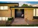Inviting front entrance features a brick landing, dual doors, and a cozy chair at sunset at 85 S Flower St, Lakewood, CO 80226