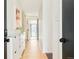 Bright hallway with light wood floors, white walls, and modern storage cabinet at 85 S Flower St, Lakewood, CO 80226
