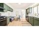 Charming kitchen with olive cabinetry, stainless steel appliances, and a cozy breakfast nook at 85 S Flower St, Lakewood, CO 80226