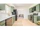 Bright kitchen with stainless steel appliances, light countertops and sleek olive-colored cabinets at 85 S Flower St, Lakewood, CO 80226