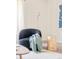 Stylish sitting area with a comfortable chair, throw blanket, and unique side table at 85 S Flower St, Lakewood, CO 80226