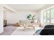 Bright living room with a large window, neutral furniture, and a modern rug at 85 S Flower St, Lakewood, CO 80226