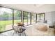 Sun room with large sliding glass doors leading to the backyard, light floors, and comfortable seating area at 85 S Flower St, Lakewood, CO 80226