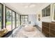 Bright sun room featuring large windows, a comfortable seating area, area rug, and stylish decor at 85 S Flower St, Lakewood, CO 80226