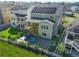 Aerial view of a gray two-story home with solar panels, a backyard, and a hot tub at 7166 S Vandriver Way, Aurora, CO 80016