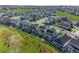 Aerial view of a neighborhood, featuring green landscapes and single Gathering homes with solar panels at 7166 S Vandriver Way, Aurora, CO 80016