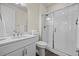 Bright bathroom featuring a glass shower, white cabinets, and modern fixtures, offering a clean and stylish space at 7166 S Vandriver Way, Aurora, CO 80016