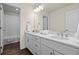 Stylish bathroom featuring a double vanity with quartz countertop, wood-look flooring and ample storage space at 7166 S Vandriver Way, Aurora, CO 80016