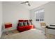 Bright bedroom with plush carpeting, simple decor, a red sofa, and natural light from a window at 7166 S Vandriver Way, Aurora, CO 80016