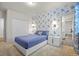 Bedroom featuring a blue bed, and floral wallpaper at 7166 S Vandriver Way, Aurora, CO 80016
