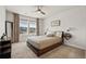 Cozy bedroom with warm-toned decor, a ceiling fan, and natural light creating a comfortable and inviting atmosphere at 7166 S Vandriver Way, Aurora, CO 80016