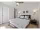 Bright bedroom with a ceiling fan, neutral walls and carpet, and a wooden bed frame with modern decor at 7166 S Vandriver Way, Aurora, CO 80016
