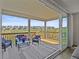 Covered deck with outdoor seating overlooking green space and surrounding community homes at 7166 S Vandriver Way, Aurora, CO 80016