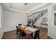 Elegant dining room featuring modern lighting, a stylish table setting, and staircase at 7166 S Vandriver Way, Aurora, CO 80016