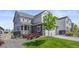 Charming two-story home with stone accents, a well-maintained lawn, and a cozy front porch at 7166 S Vandriver Way, Aurora, CO 80016