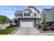 Beautiful two-story home features a stone facade, two-car garage, and well-manicured lawn at 7166 S Vandriver Way, Aurora, CO 80016