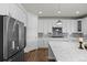 Contemporary kitchen featuring white cabinets, stainless steel appliances, and granite countertops at 7166 S Vandriver Way, Aurora, CO 80016