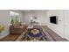 Comfortable living room with plank flooring, an oriental rug, natural light, and a wall-mounted television at 7166 S Vandriver Way, Aurora, CO 80016