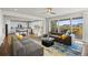 Open living area showcases modern kitchen, access to deck with outside views, wood floors, and neutral wall colors at 7166 S Vandriver Way, Aurora, CO 80016