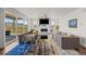 Cozy living room with fireplace, ceiling fan, large windows, and an access to the patio with a great outdoor view at 7166 S Vandriver Way, Aurora, CO 80016