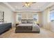 Large main bedroom featuring a tray ceiling, neutral walls, and soft carpet, offering a serene and inviting atmosphere at 7166 S Vandriver Way, Aurora, CO 80016