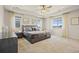Spacious main bedroom with tray ceiling, carpeted floor, and large windows creating a bright and airy retreat at 7166 S Vandriver Way, Aurora, CO 80016