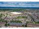 Aerial view featuring residential housing, commercial centers, and nearby landscape highlighting the area's connectivity at 1162 Rockhurst Dr # 404, Highlands Ranch, CO 80129