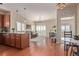 Open-concept living room featuring hardwood floors, modern lighting, and natural light, with a view from the kitchen island at 1162 Rockhurst Dr # 404, Highlands Ranch, CO 80129