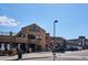 Exterior of a restaurant and pub, featuring outdoor seating, architectural details, and street access at 1162 Rockhurst Dr # 404, Highlands Ranch, CO 80129