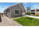 Well-manicured lawn and landscaped yard surrounding a charming gray home at 311 Josef Cir, Fort Lupton, CO 80621