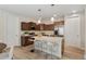 Contemporary kitchen featuring an island with seating, stainless appliances, and ample cabinet space at 311 Josef Cir, Fort Lupton, CO 80621