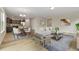 Open-concept living area with modern furniture and hardwood floors perfect for entertaining at 311 Josef Cir, Fort Lupton, CO 80621