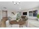Bright living room featuring hardwood floors, modern lighting, and contemporary decor at 311 Josef Cir, Fort Lupton, CO 80621
