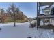 Snowy backyard with a view of neighboring homes at 592 Bristolwood Ln, Castle Pines, CO 80108