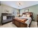 Bright bedroom with a crib and double bed at 592 Bristolwood Ln, Castle Pines, CO 80108