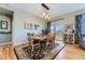 Bright dining room features hardwood floors, a wood table, and access to a deck at 592 Bristolwood Ln, Castle Pines, CO 80108