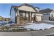 Two-story house with a front porch, landscaping, and driveway at 592 Bristolwood Ln, Castle Pines, CO 80108